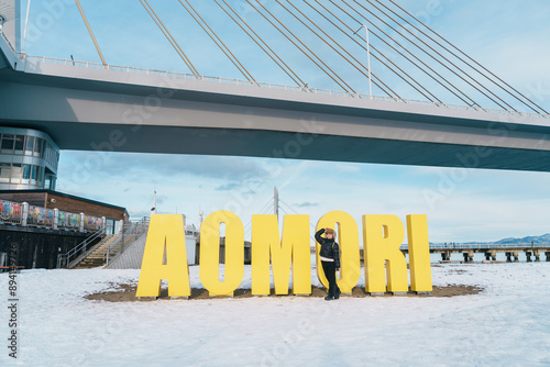 Woman tourist sightseeing Aomori Bay Bridge area, Traveler travel in Aomori city, Aomori Prefecture, Japan. Landmark for tourist attraction, travel and vacation photo