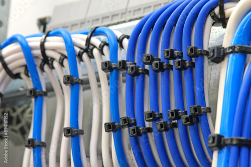 Plastic ties for tightening insulated copper electrical wires. Close-up. Soft focus.