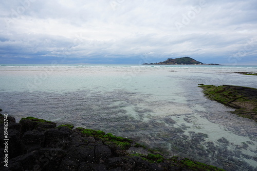 clear shoaling beach and far island photo