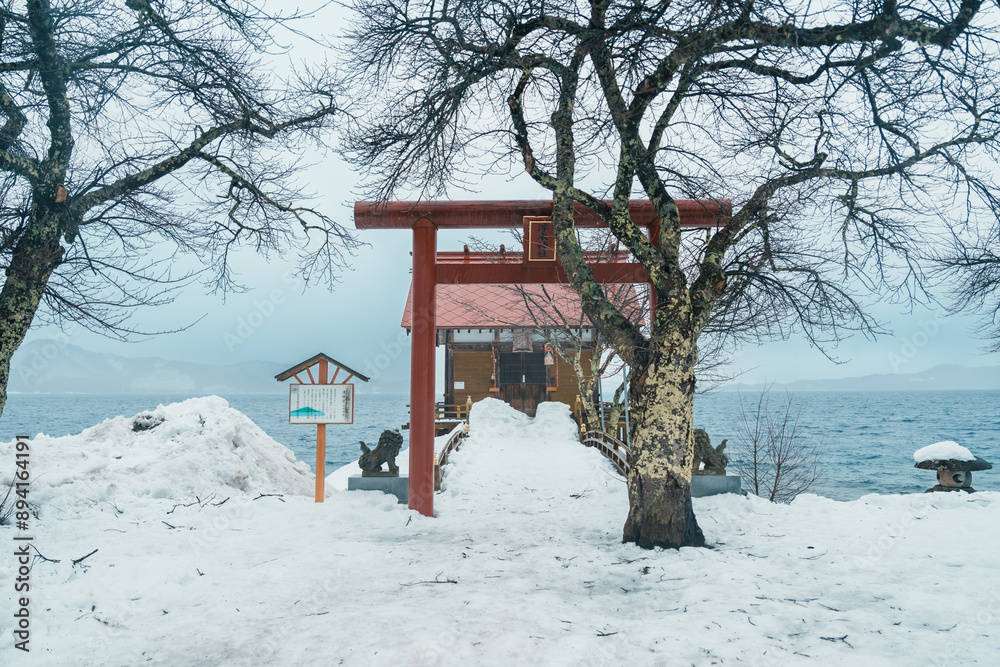 Kansa Shrine and Lake Tazawa with snow in winter season. located in Semboku city, Akita Prefecture, northern Japan. Landmark and famous for tourists attractions in Tohoku region, Japan Kansa Shrine and Lake Tazawa with snow in winter season. located in Semboku city, Akita Prefecture, northern Japan. Landmark and famous for tourists attractions in Tohoku region, Japan