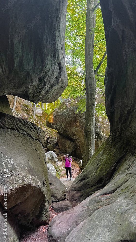 man tourist hiking by rocks on forest man tourist hiking by rocks on forest