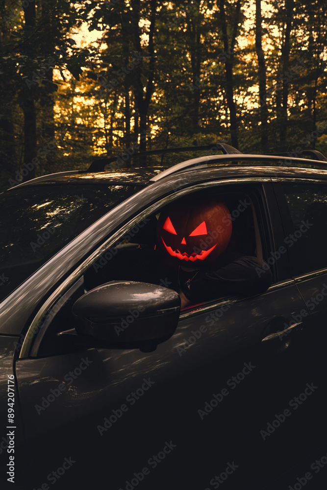 halloween concept man with pumpkin head in suv car