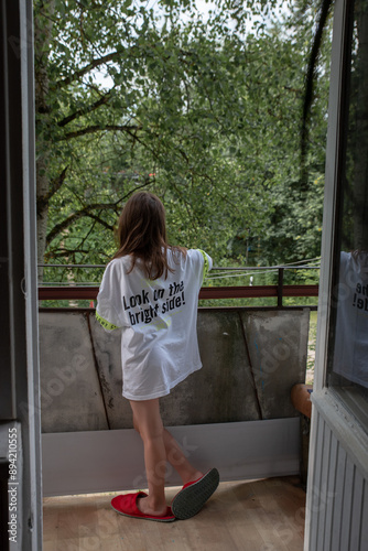 a girl in a white T-shirt on the balcony