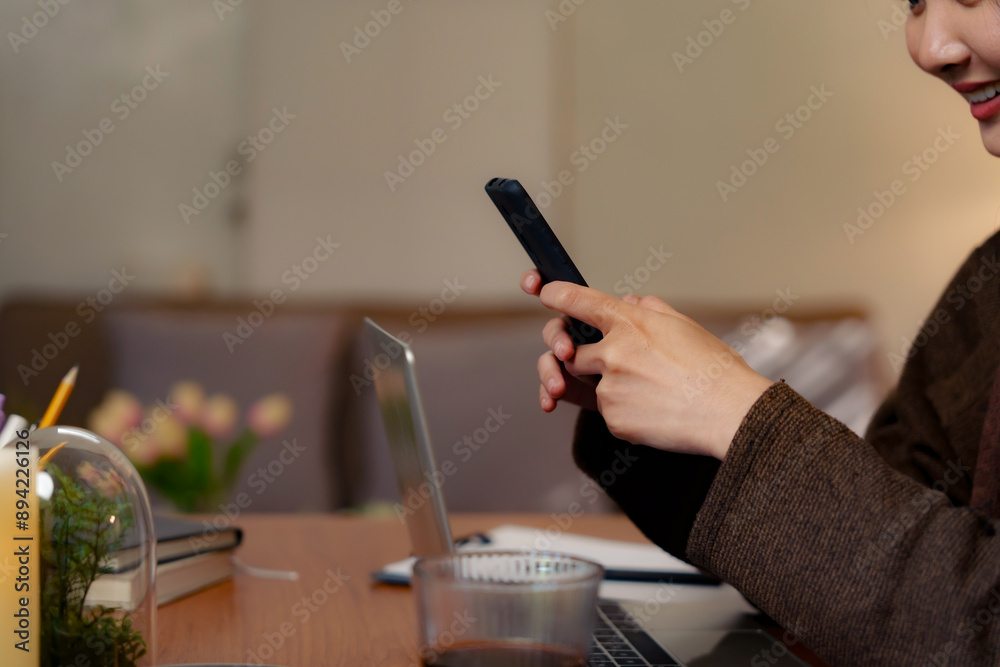 Asian girl using cell phone for checking social media at home holding smartphone in morning Asian girl using cell phone for checking social media at home holding smartphone in morning