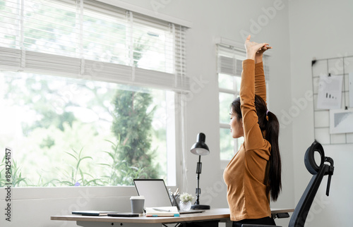 Wallpaper Mural Beautiful women exercises and stretching in front of a laptop. Sitting Working at home, Torontodigital.ca