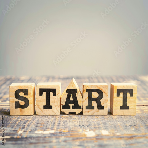 Wooden blocks spelling 'START' on a rustic table, symbolizing new beginnings and opportunities in life and business.