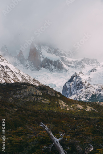 A mountain range covered in snow and trees. The sky is cloudy and the mountains are covered in snow photo