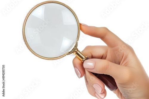 A female hand holding a magnifying glass isolated on a white background.