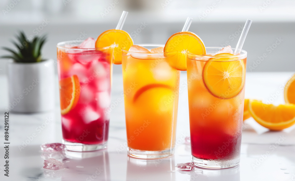 Refreshing citrus drinks with ice and fruit slices in glasses. Refreshing citrus drinks with ice and fruit slices in glasses.