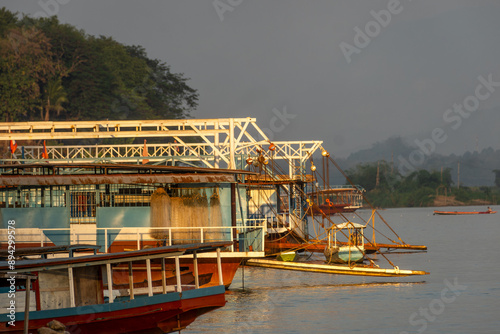 Sunset cruise along the Mekong River on traditional boats transformed into a boat for tourists in Luang Prabang, Laos, © hectorchristiaen