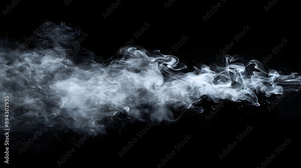 Obraz premium A dynamic swirl of white smoke gracefully trails against a stark black background, creating a sense of movement and mystery.