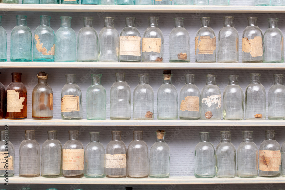 Old glass bottles on a shelf as a background