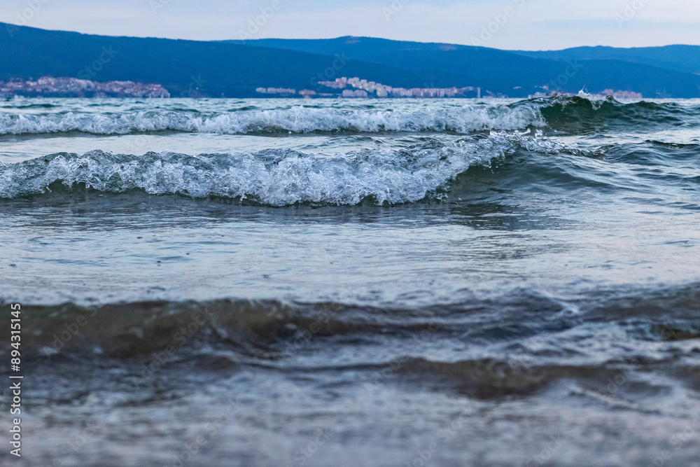 close-up of waves rolling onto the shore, salty spray flying through the airwaves roll onto the shore close-up of waves rolling onto the shore, salty spray flying through the airwaves roll onto the shore