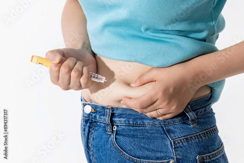 A woman injecting herself with obesity medication