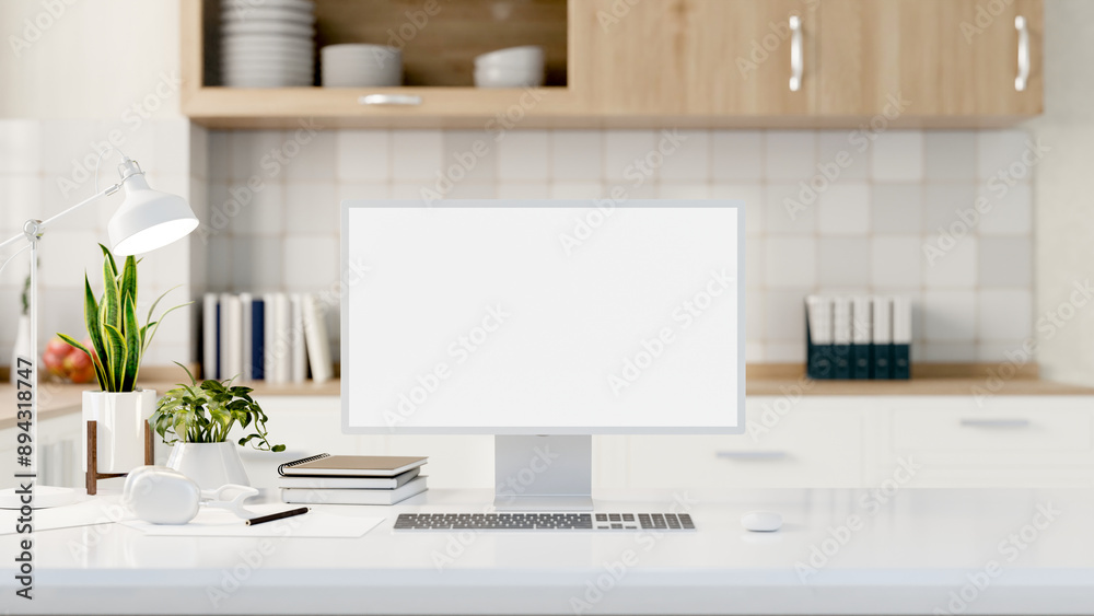 A computer with a white-screen mockup on a white table with a blurred background of a modern kitchen A computer with a white-screen mockup on a white table with a blurred background of a modern kitchen
