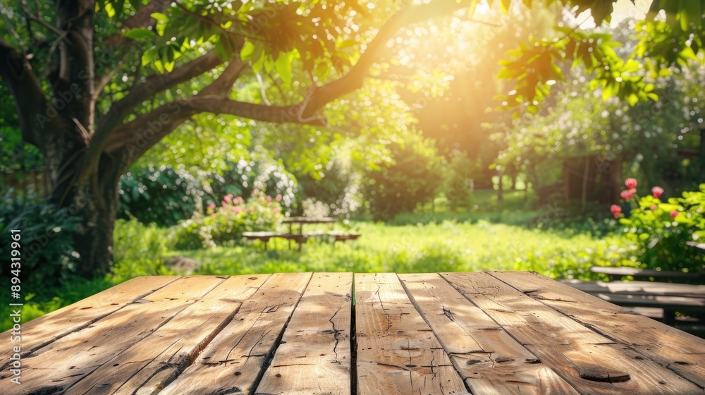 Wooden table in summer garden for product background and picnic display Wooden table in summer garden for product background and picnic display