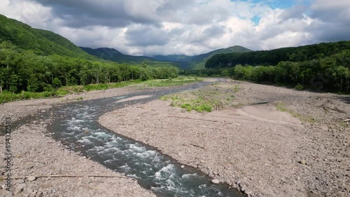 Hokkaido, Japan: Aerial drone footage of the Chubetsu river in the Asahidake mountain in the Daisetsuzan volcanic Group near Asahikawa in Hokkaido on a cloudy summer day in Japan photo