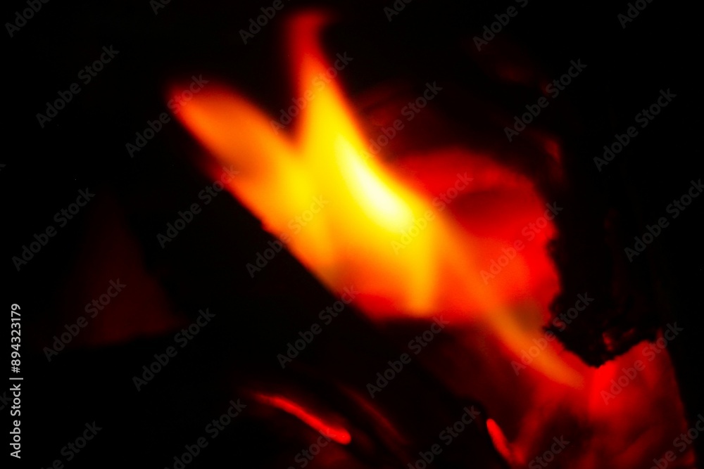 Close-up of burning log in bonfire. Large orange flame from fire with woods. Light and ash from wood in balefire.