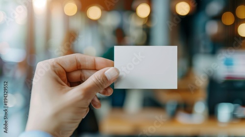 Hand Holding Blank Card with Blurred Background