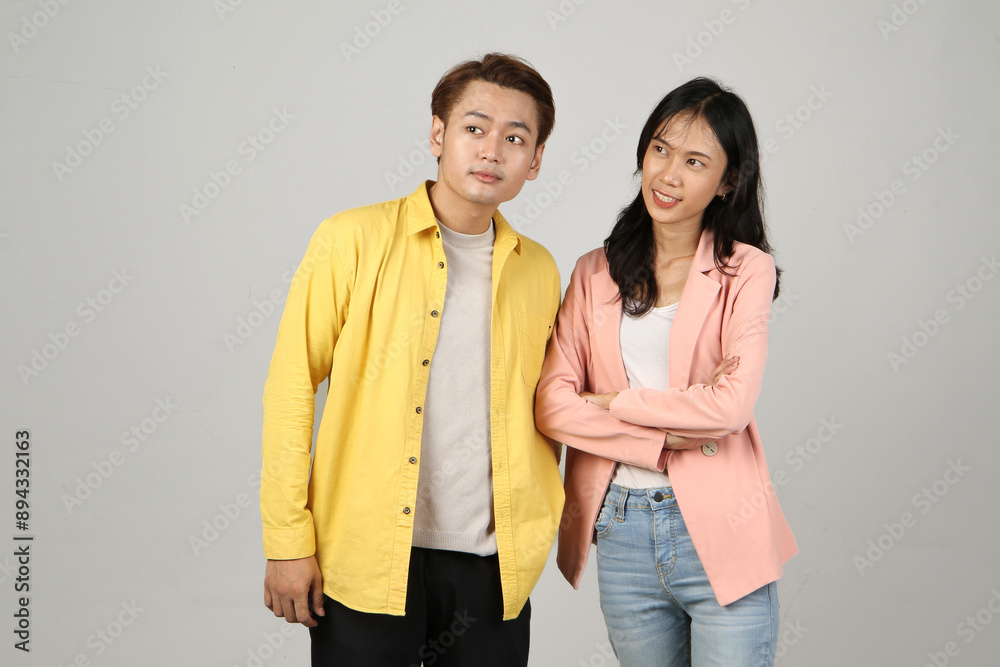 portrait of pensive asian Indonesian couple with thinking gesture on isolated background portrait of pensive asian Indonesian couple with thinking gesture on isolated background