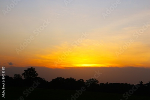 Sunset Sky cloud in the Morning Sunrise with Orange, Yellow Golden Hour Sunrise on Summer season, Horizon Dusk Sky Dramatic Nature Background