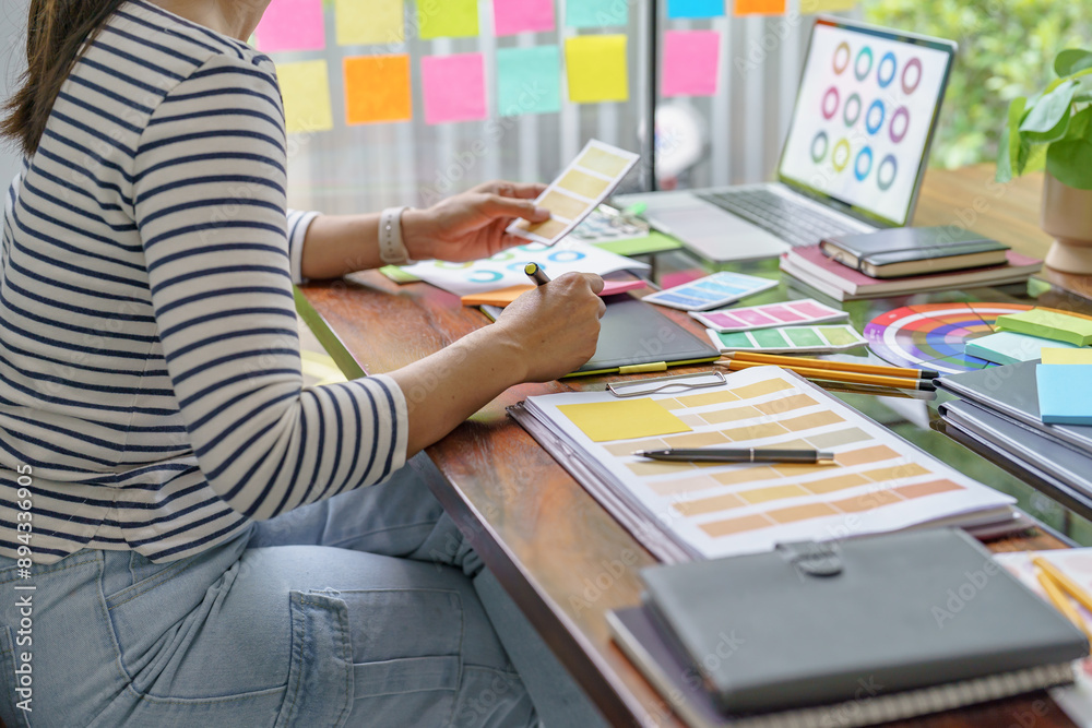 Teamwork brainstorming Creative idea Business project. Business People meeting taking notes while discussing with Color swatch samples to share idea Teamwork brainstorming Creative idea Business project. Business People meeting taking notes while discussing with Color swatch samples to share idea