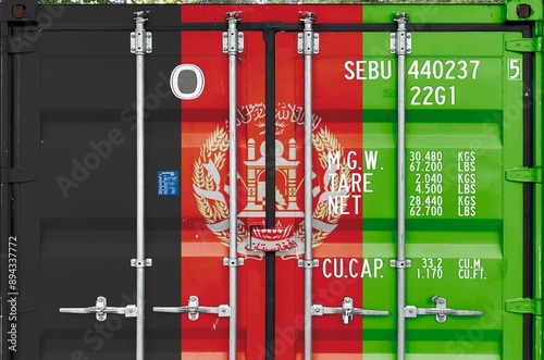 Afghanistan flag depicted on metal doors of shipping cargo container outdoors in docks area close up photo