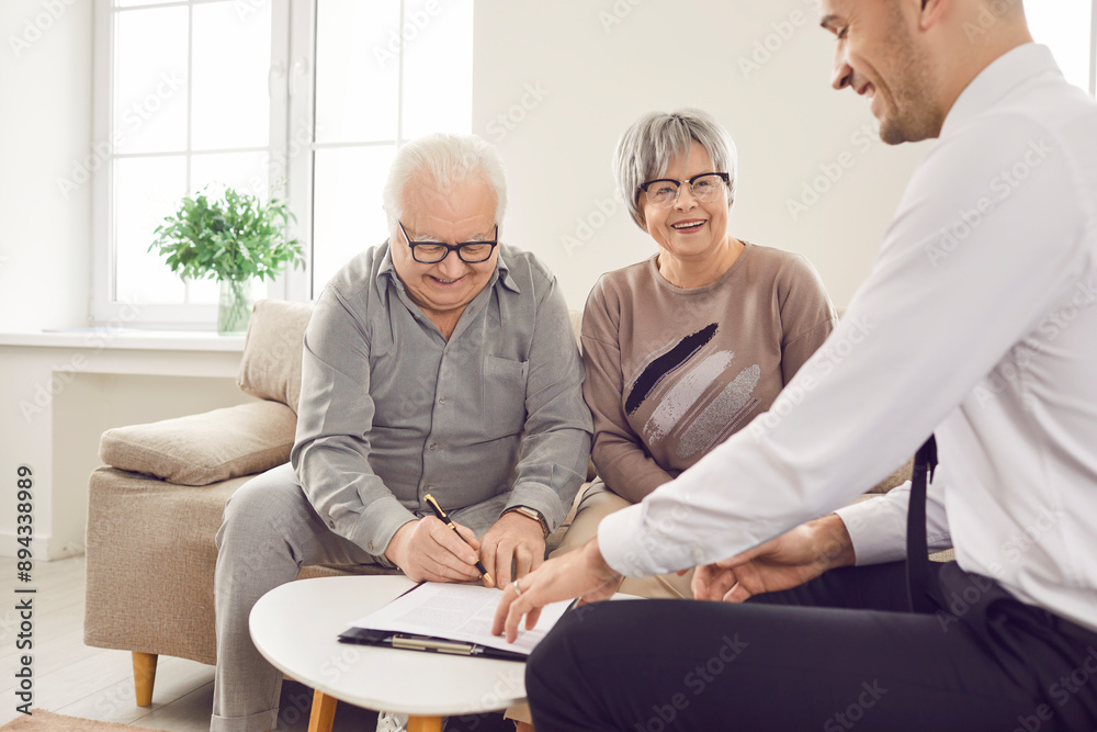 Obraz premium Real estate office realtor helps happy senior couple sign property purchase agreement. Contract signing process positive and empowering experience. Signing real estate contract is new chapter of life