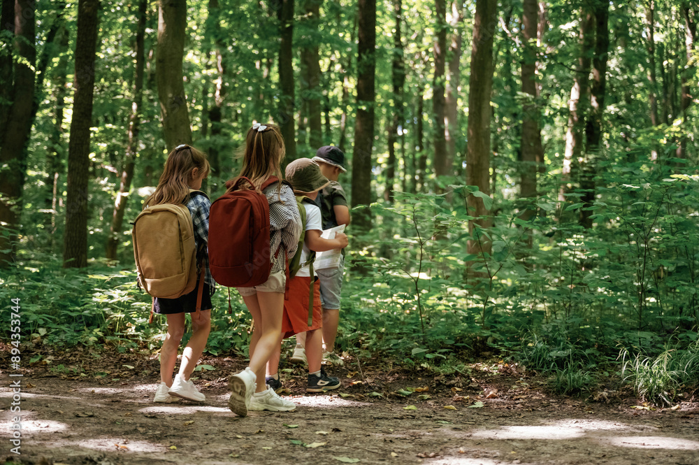 Long way, exploring. Kids in forest at summer daytime together Long way, exploring. Kids in forest at summer daytime together