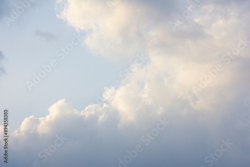 It's a blue sky with atmospheric puffy clouds.