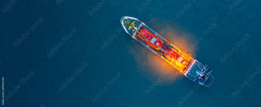 Aerial view Oil and Gas tanker ship LPG tanker ship transportation oil and gas from refinery on the sea at night, Oil and Gas tanker ship global business logistic refinery transportation. Aerial view Oil and Gas tanker ship LPG tanker ship transportation oil and gas from refinery on the sea at night, Oil and Gas tanker ship global business logistic refinery transportation.