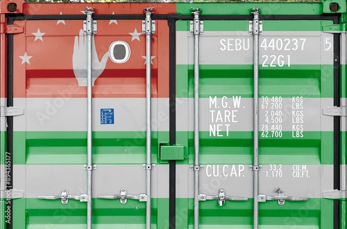 Abkhazia flag depicted on metal doors of shipping cargo container outdoors in docks area close up photo