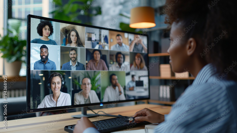 Employees joining virtual business conference via TV monitor in boardroom setting Employees joining virtual business conference via TV monitor in boardroom setting