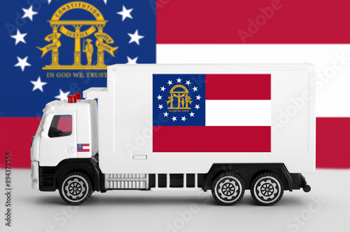 Georgia US state flag depicted on side wall of white delivery van close up. Shipping and local delivery concept