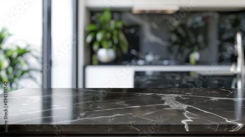 A sleek, black marble top on a kitchen island. © vefimov