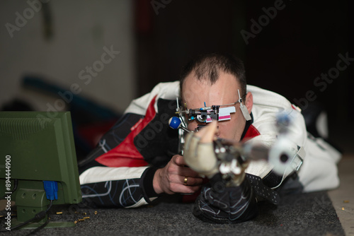 A dedicated male athlete practices for an upcoming competition during a sports shooting training session, known for his focus, precision, and commitment to excellence in his shooting skills.