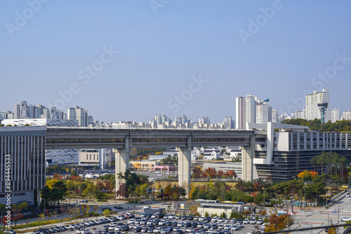 Sejong-Si, South Korea - October 30, 2022: High angle and autumnal view of cars parked on parking lot with buildings of Government Complex Sejong at Eojin-dong
 photo