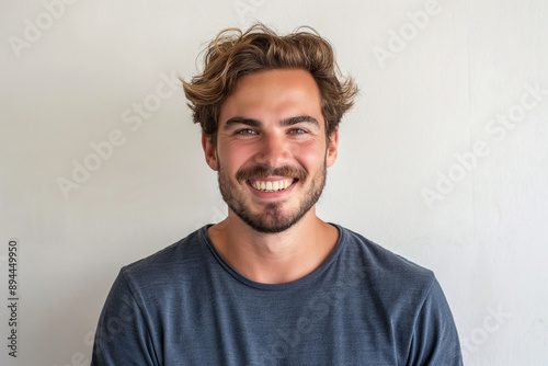 Smiling Man with Curly Hair Against White Background