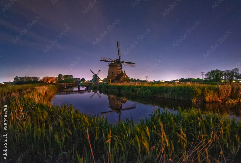 Fototapeta premium reflection of windmill in dutch countryside