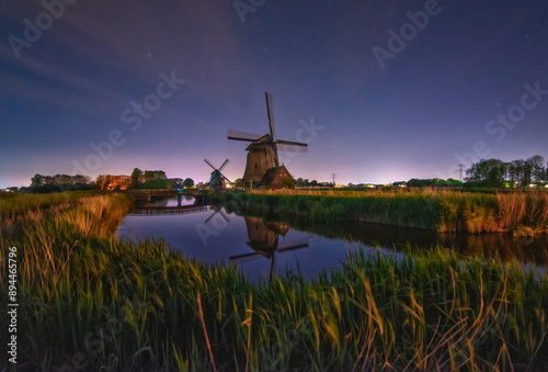 reflection of windmill in dutch countryside