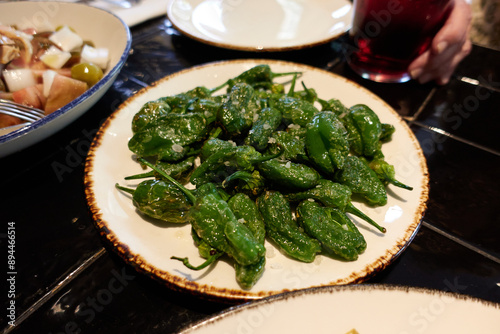 White plate with padron peppers