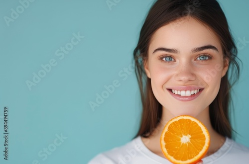 Woman Holding Orange Slice Over Eye