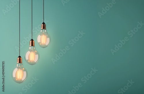 Single Lightbulb Hanging Against Teal Wall