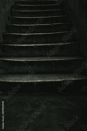 Scary stone stairs in dark light in an old house