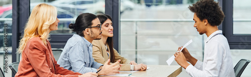 A diverse group of professionals engaging in a productive meeting in a modern office setting.
