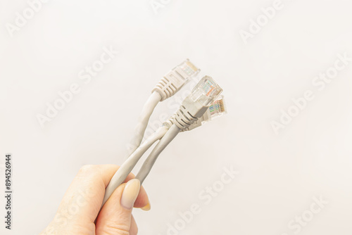 Woman holds internet wires with connectors. Network cables photo