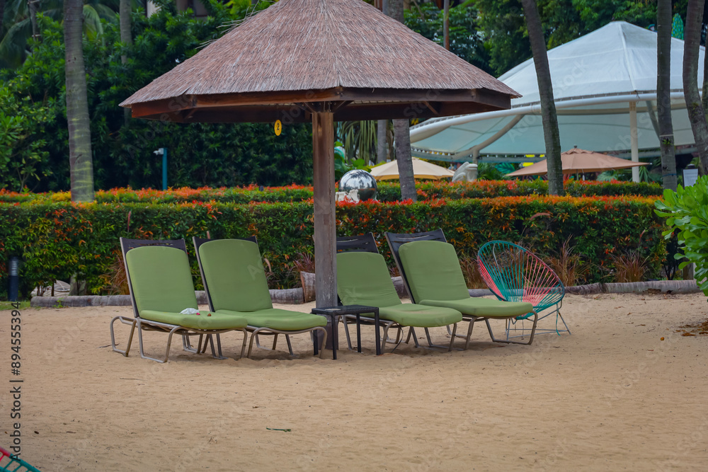 Resting beach bed (high resolution photos) with green cushions at Sentosa beach, Singapore. No people as the beach is closed to public owing to an oil spilage. Resting beach bed (high resolution photos) with green cushions at Sentosa beach, Singapore. No people as the beach is closed to public owing to an oil spilage.