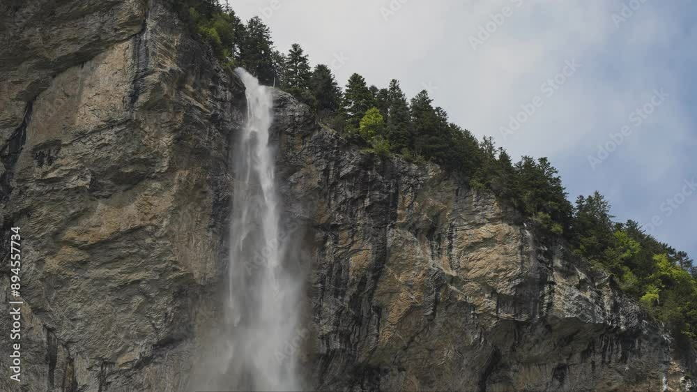 Discover a breathtaking waterfall in Lauterbrunnen surrounded by the Swiss mountains, a serene and stunning natural sight to explore Discover a breathtaking waterfall in Lauterbrunnen surrounded by the Swiss mountains, a serene and stunning natural sight to explore