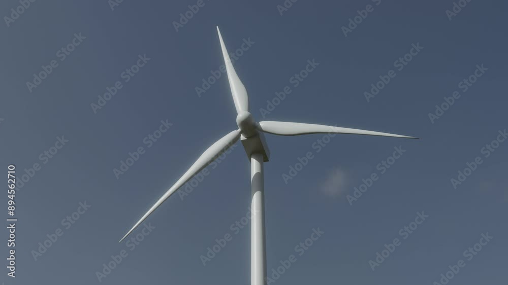 A modern wind turbine harnesses wind energy under a clear blue sky, generating clean electricity A modern wind turbine harnesses wind energy under a clear blue sky, generating clean electricity
