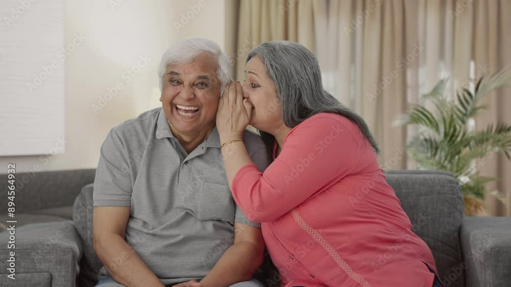 Happy Indian old wife telling a secret to her husband in ear Happy Indian old wife telling a secret to her husband in ear